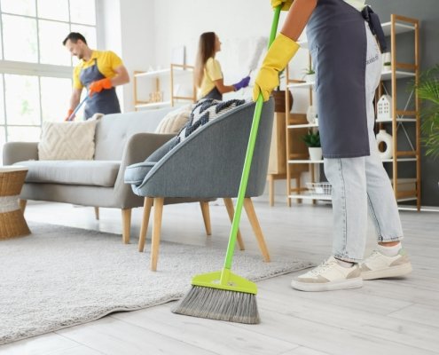 Female,Janitor,Sweeping,Floor,In,Room